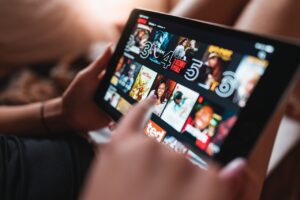 Person scrolling through Netflix on a tablet