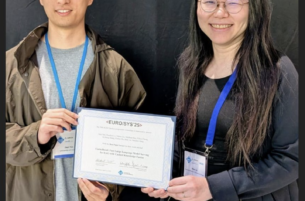 students accepting best paper award