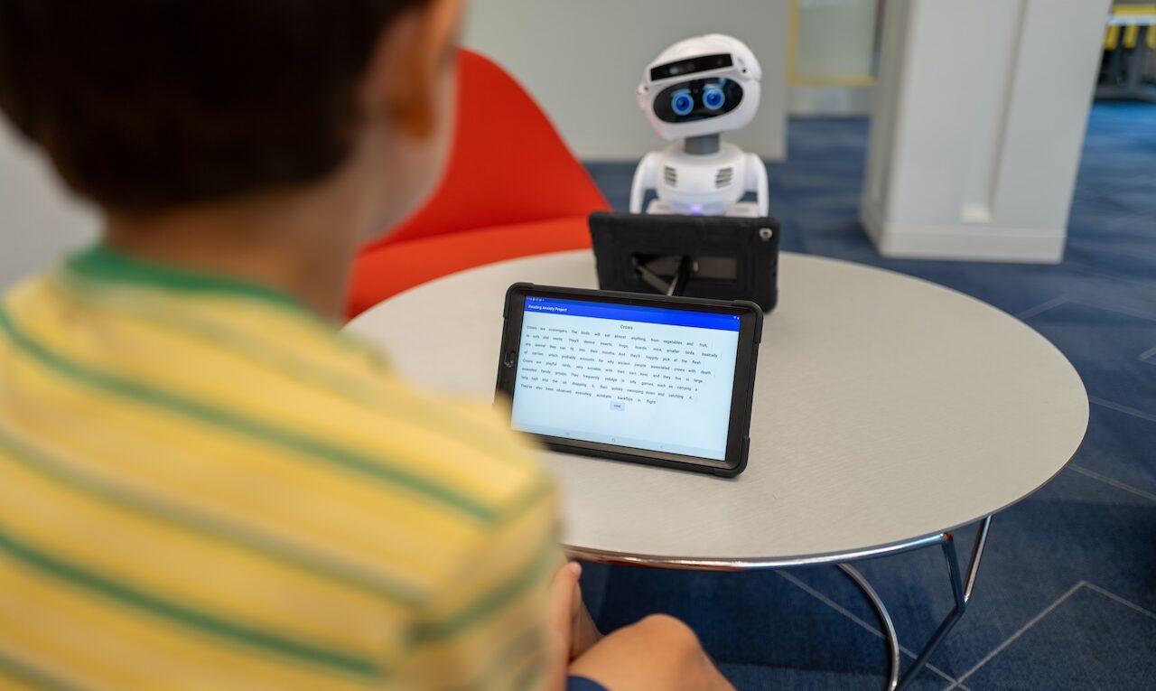 child reading to robot