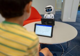 child reading to robot